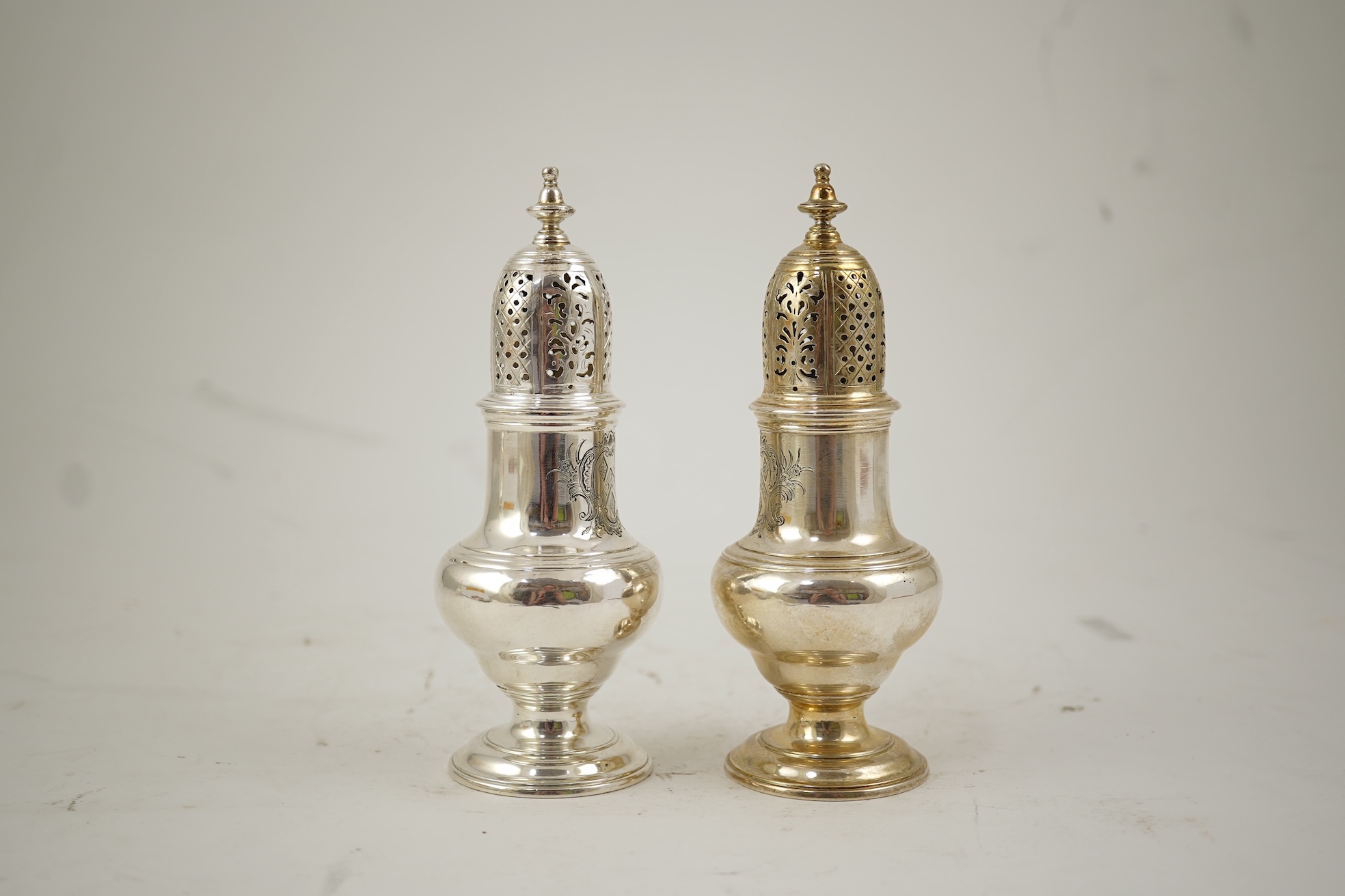 A pair of George II silver baluster sugar casters, by Samuel Wood